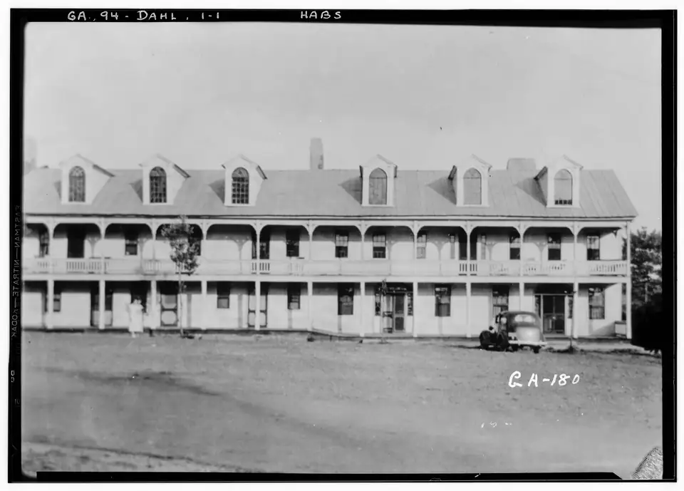 1936 survey photograph of the long two-storey Old Hotel with a double porch on the Dahlonega square