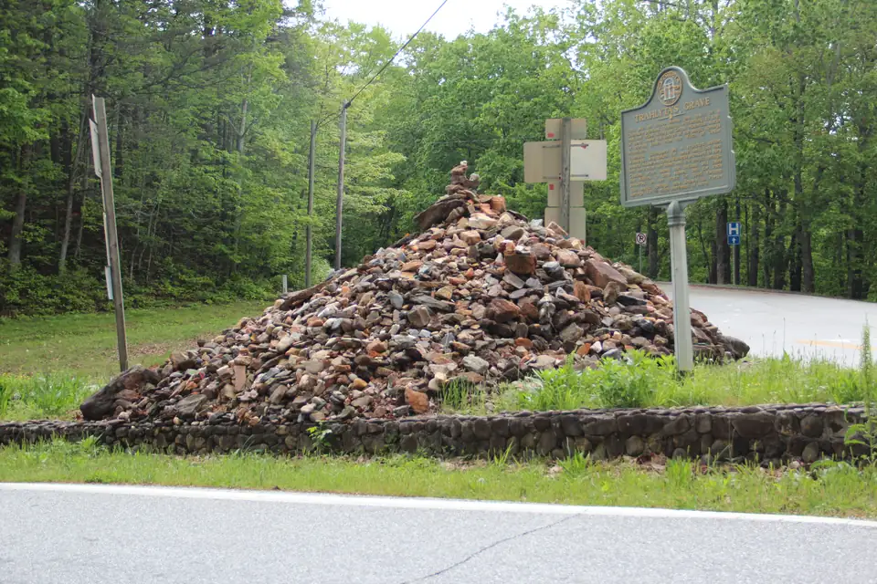 Trahlyta's Grave at Stonepile Gap, a large cairn of stones inside a low wall beside a Georgia historical marker
