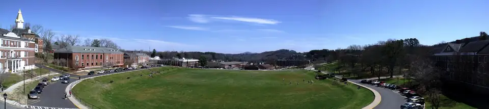 Panorama of the University of North Georgia drill field in Dahlonega with wooded ridges beyond